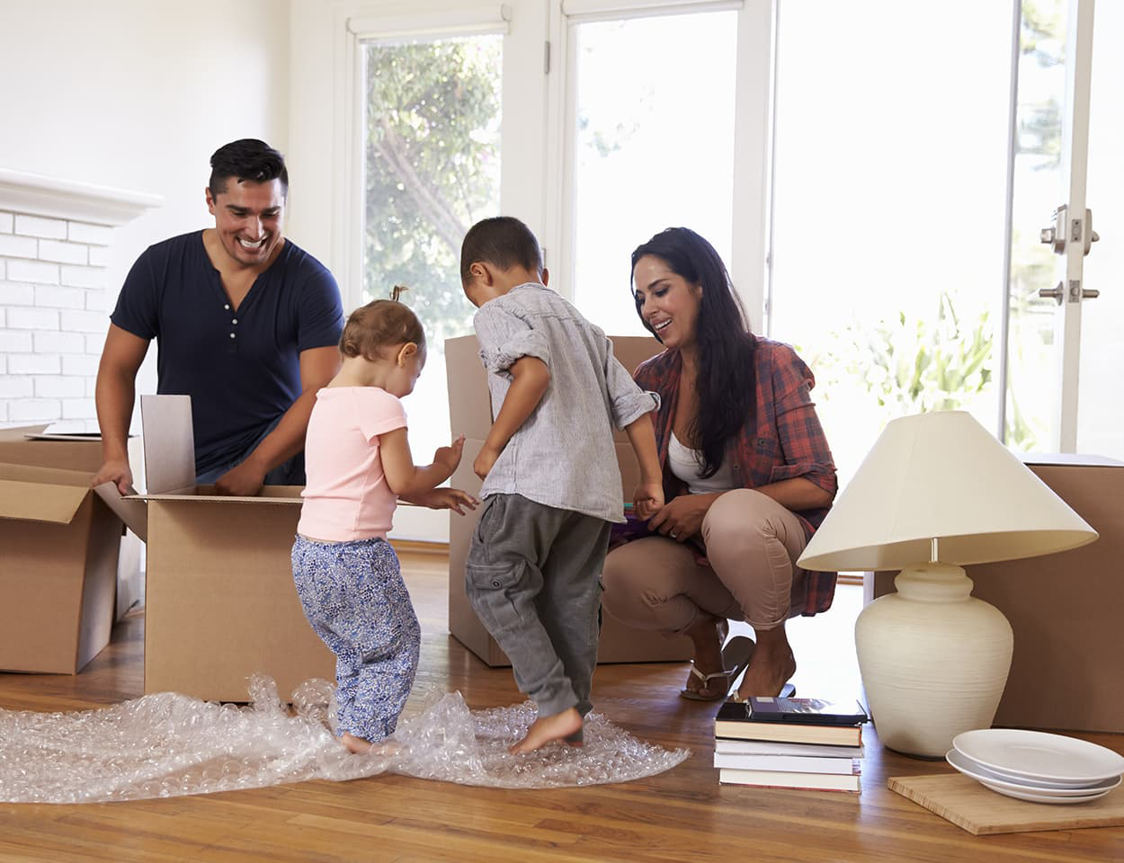 Happy family unpacking boxes